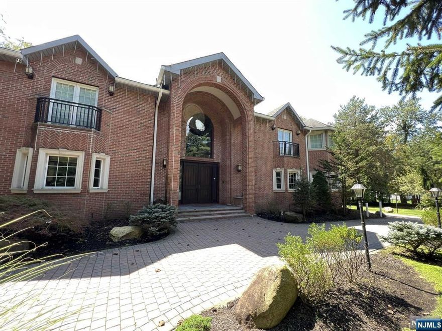 Welcome to this elegant 7,400 sq ft brick manor in Demarest, located across from the NYC express bus. Step into the grand foyer with radiant limestone floors and a Cinderella-style staircase, setting the tone for luxury throughout. The open-concept design leads to a bright living space with soaring ceilings and large windows that fill the home with natural light. The gourmet kitchen, perfect for entertaining, features a large island, pantry, and high-end finishes, seamlessly flowing into the spacious dining room. The adjacent great room, with a fireplace and oversized windows, offers serene views and a cozy retreat. Upstairs, you'll find 4 ensuite bedrooms, each with its own private balcony. The lower level offers two rooms with ensuite baths, a soundproof movie room with wet bar, sauna, steam shower, laundry, and yard access. With a circular driveway, gated entrances, and a 3-car garage, this home offers both convenience and elegance.