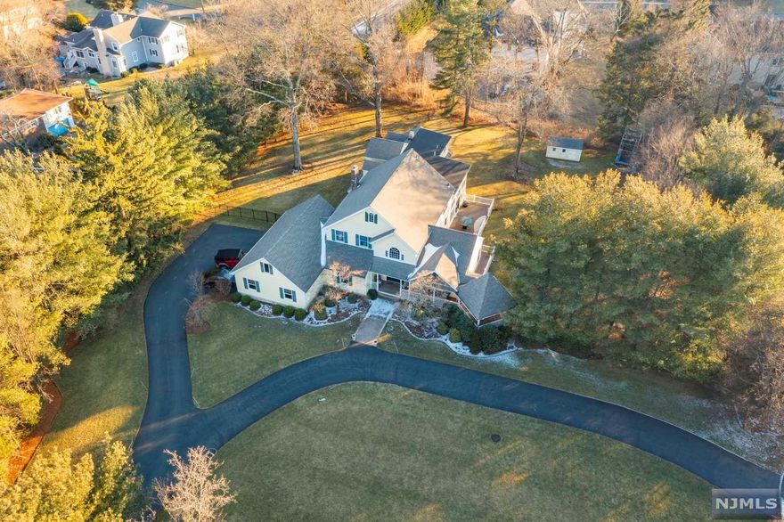 What a Home! Enter the front doors off of the wrap-around porch into a 2 story foyer with hardwood floors and a gorgeous open staircase. Follow the hall past the gorgeous Formal Dining Room with a custom built-in buffet, wood-burning FP, and beautiful coiffured ceiling, directly into the Great room with a wall of windows letting in Natural Light all day long. The kitchen is off the great room with an adjacent sitting/craft room with a second Wood FPL. The first floor is finished with 2 Full Bath, Laundry, an incredibly upgraded game room with a vaulted ceiling and deck access, and a guest/in-law/5th bedroom. The second floor offers 3 generous sized bedrooms, a bonus/sitting area full bath, and a Primary suite with a separate sitting/office area and vaulted ceilings. All of this on almost 1.4 acres, with whole house generator, fenced-in yard, new central AC, wrap-around porch with gazebo, and large deck for entertaining. Located in a private Cul De Sac with only 3 homes.
