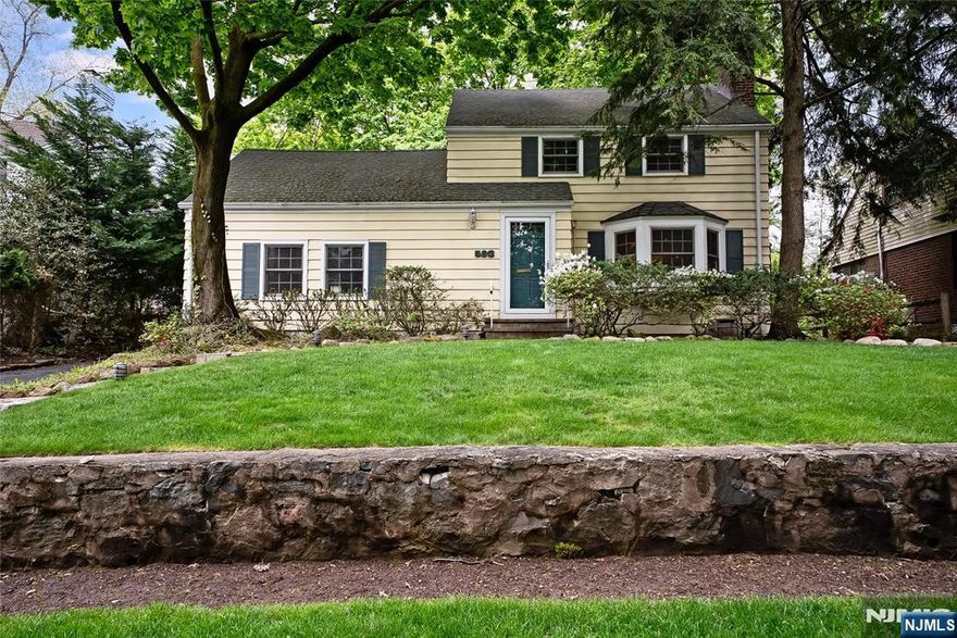 On a charming street many never knew existed, this beautifully set-back side-hall Colonial offers a true sense of privacy and serenity. A welcoming entrance hall leads to a gracious living room with fireplace, a formal dining room, and a generously sized family room or home office with access to the kitchen. From the entry, a separate staircase leads down to an additional spacious family roomâ€”perfect for entertaining or relaxing. The kitchen features granite countertops, a delightful breakfast nook, and opens to a stunning blue slate patio and private backyard, creating an ideal indoor-outdoor lifestyle. The second floor offers three generously sized bedrooms and a beautifully appointed full bath. Additional highlights include central air conditioning, a backup generator, roof heating coils and thoughtful upgrades throughoutâ€”providing comfort and peace of mind. A true haven of serenity, just minutes from New York transportation and parks.
