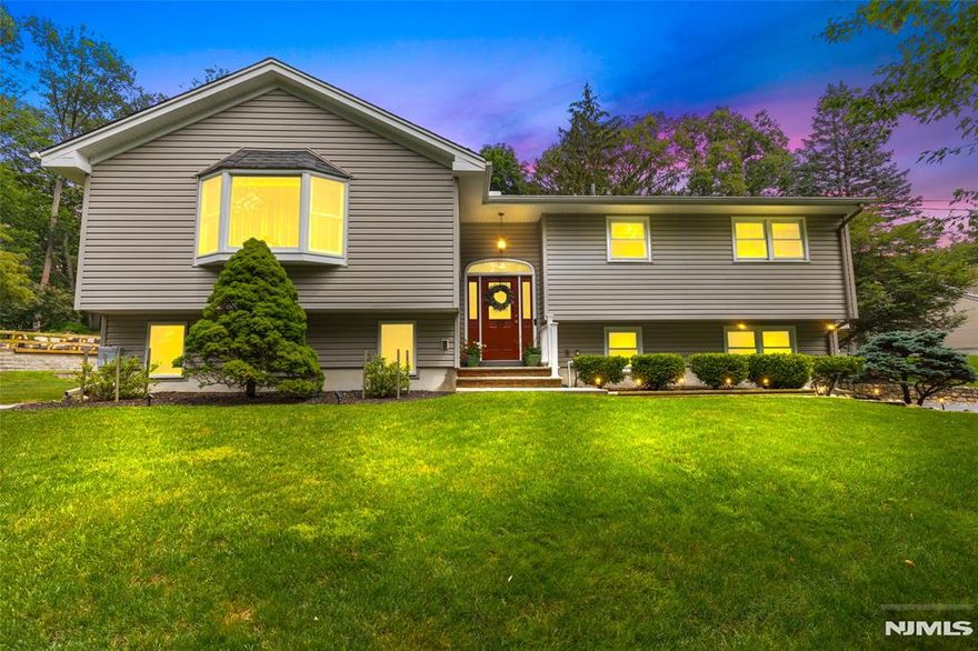 For more information on this home please contact Andrew Delgado- 347-502-8546 Welcome to this beautifully maintained home in a peaceful neighborhood setting. The main level features a spacious living room anchored by a masonry wood-burning fireplace, creating a warm and inviting atmosphere that flows seamlessly into the dining area, three-season porch, and a modern eat-in kitchen with tile floors, stainless steel appliances, and quartz countertops. Two bedrooms, a full hall bath, and a primary suite with private bath complete this level. Downstairs, the ground floor includes a fourth bedroom and a large entertainment room that opens to a covered patio perfect for indoor-outdoor gatherings. Additional highlights include laundry, access to a two-car garage, and a paver patio at the edge of the property ideal for enjoying tranquil sunsets.