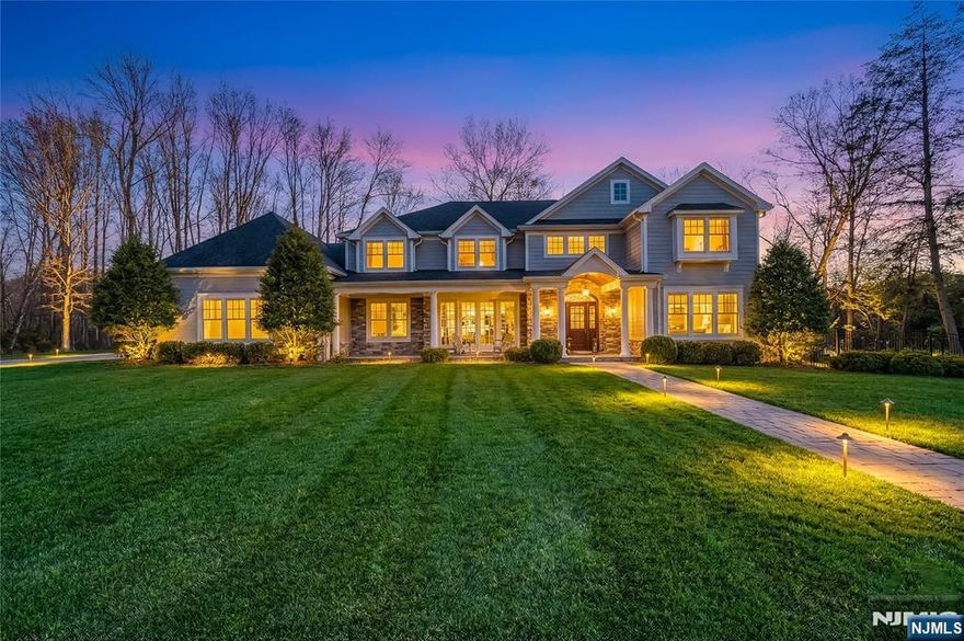 Welcome to 106 Koch Lane, a spectacular luxury residence nestled on a quiet cul-de-sac in the heart of Old Tappan, located within the townâ€™s highly sought-after Blue Ribbon school district. This impressive custom-built home spans approximately 5,914 square feet on an expansive 0.87-acre lot, offering exceptional space, privacy, and modern design. A dramatic two-story foyer introduces an elegant layout ideal for todayâ€™s lifestyle, featuring a first-floor bedroom, private home office, formal living room, and a spacious family room with a gas fireplace. The modern eat-in kitchen features a large center island and sliding glass doors leading to the patio, creating seamless indoor-outdoor living. A custom wet bar with sink connects to the formal dining room, perfect for entertaining. The second level offers four generously sized bedrooms, a second laundry room, and a large recreation space ideal for a gym, media room, or playroom. The primary suite includes his and her walk-in closets and a beautifully appointed bath with double vanity, soaking tub, and separate shower. Thoughtful design and impressive scale create a warm yet refined living experience in one of Bergen Countyâ€™s most desirable communities.