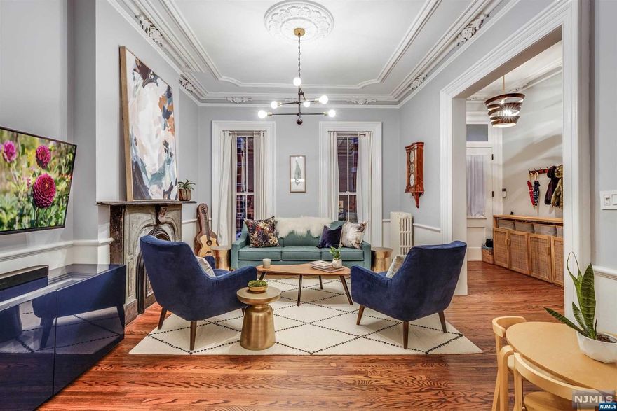 A unique and rare opportunity awaits in historic Hamilton Park, 211 7th St - a timeless, grand Brownstone exuding original charm at every turn. This distinguished multi-family residence, nestled on one of Jersey City's most coveted streets, unfolds over four exquisite floors, revealing 5 bedrooms and 3.5 baths that seamlessly blend an air of history with contemporary luxury. As you step through the entrance, the parlor level unfolds a spacious haven featuring an open living room, dining room, and kitchen adorned with remarkably high ceilings. A sense of history and elegance pervades, accentuated by an original fireplace in the living room and dining room. The kitchen, a culinary masterpiece, boasts quartz countertops, top-tier stainless steel appliances, including a sub-zero refrigerator, and an inviting island - a hub for family gatherings and socializing with friends. Beyond the kitchen lies a sunroom, adorned with French windows and skylights, this sunlit sanctuary seamlessly c