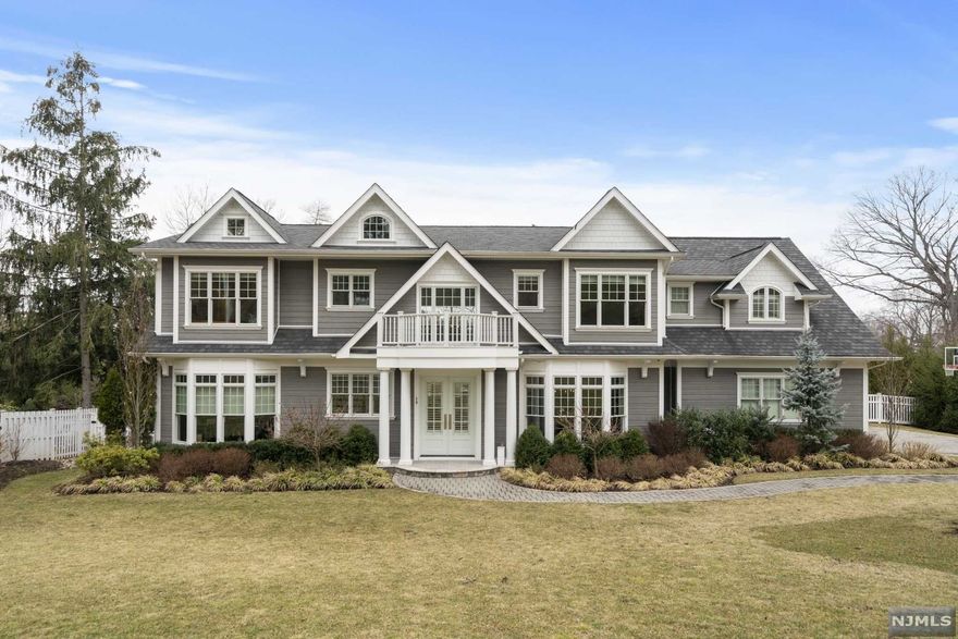 This gorgeously designed luxury home is set on a tree lined cul-de-sac street on the East Hill of Tenafly. Only 5 years young, built in 2017, this home is a MUST SEE. Enter into your two-story foyer to the ultimate open entertaining layout. NANO glass doors span most of the home's back wall and provide an abundance of natural light and a breathtaking view of your resort style backyard, equipped with a roof covered outdoor kitchen and dining area, infinity pool and a hot tub. First floor also boasts wide plank hardwood floors, Wolf and Subzero kitchen appliances, gorgeous molding and reclaimed wood/shiplap details on the ceiling and throughout. Upstairs your primary suite has a beautiful sitting area, large his/hers custom closets, spa like primary bath with an extraordinary 2 person shower, and a stand-alone soaking tub. 3 additional ensuite bedrooms and a laundry room complete the home's second level. Basement is equipped with a theatre room and wet bar, 2 bedrooms, full bath.