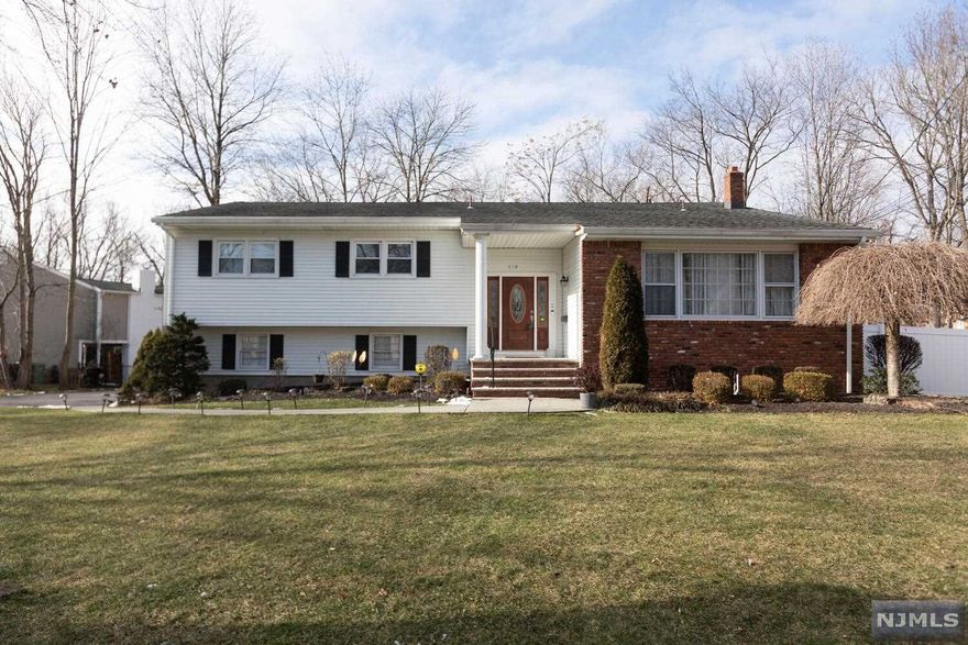 This Immaculate Updated 4-Bedroom Sugar Maple sits on a 100x152' lot among similar homes in a quiet neighborhood just a short walk to House of Worship and NYC Bus. Beautiful Refinished Hardwood Floors, Formal Dining Room, Formal Living Room, Modern Eat-in Kitchen with Breakfast Area, Center Island, Family Room, MBR w/WIC & MBth, 2 additional BR's plus Full Bath complete the upper floor. Lower Level has Family Rm w/FPL, Sliding Door to Covered Patio, Bedroom, Full Bath and Entrance to oversize 2-Car Garage plus ample parking for up to 8 additional cars. Lower Level has Playroom/Exercise Room, Laundry and Utility Room. Fresh Paint throughout, New Recessed Lighting, Nice size private fenced rear yard Newer Water Heater, Refinished Deck, 6 yr old roof, Close to schools and parks, convenient to shopping and major highways. Live in Paramus with Good Schools and Great Shopping.