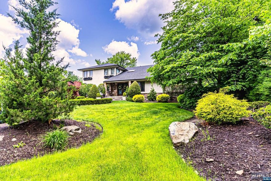 Stunning Home in the highly desirable Neighborhood of EC with Blue Ribbon School! This beautiful OS Property will instantly captivate you. A cobblestone and Paver Dway, meticulous LS and a lovely exterior greet you upon arrival! This home features a spacious Fl Plan.HDWD floors throughout the home.FDR,Sunken LR with atrium built in seating. Chef Kitchen W Miele/SZ APPL,PR,Den/Ensuite BR, LG.FAM RM with built-ins, Double Sided Stone FP, Wrought Iron Railing,MLD and fine style trim rounds off the 1st Level Upstairs you will find 4 BR's,2 Rm BR.Natural LG from skylights and corner windows from each room w breathtaking views. Spacious Ensuite Primary BR w built-ins. Fully finished BM, Full BR,LDR,Gym,Office,Mud Rm,Step outside through the elegant French Doors off the Kit and transform into Paradise! Massive Terrace, Full outdoor Kitchen,Bar, Wdbrn Pizza oven. Step down to a magnificent In-ground gunite salt water heated pool beautiful LS which offers full privacy A must see