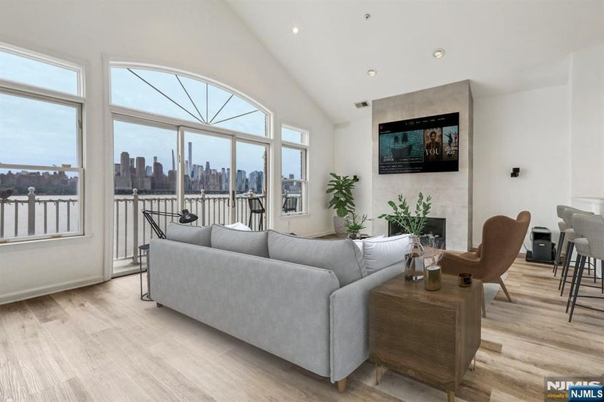 Welcome to this stunning and sophisticated 3 Bedroom Fulton style waterfront home, where elegance meets modern convenience. Thoughtfully designed to capture sweeping panoramic views of the New York City skyline, this sunlit residence offers soaring ceilings and a spacious open-concept layout tailoring contemporary living. The expansive living room opens to a private deck through oversized sliding glass doors, seamlessly blending indoor and outdoor living. A chefâ€™s dream, the gourmet kitchen is outfitted with premium finishes and ample space for entertaining. Every detail is carefully curatedâ€”from designer lighting in the dining area to gallery-quality LED and recessed lighting throughout the living spaces and bedrooms. Enjoy luxury with a European-inspired powder room and a spa-like primary bath featuring a soaking tub and skylight. California Closets provide exceptional storage and organization, enhancing both style and function. Additional highlights include a private in-home elevator and parking for two vehiclesâ€”one in a private garage and one in the driveway. Residents enjoy access to resort-style amenities, including two pools with jacuzzis, a tot-lot, and a complimentary shuttle to the ferry and light rail. For commuters, a direct bus to Port Authority is steps away. With dining, shopping, and everyday conveniences nearby, this home truly offers the best of both worlds. A luxurious retreat with every modern comfortâ€”perfect for today's on-the-go lifestyle.