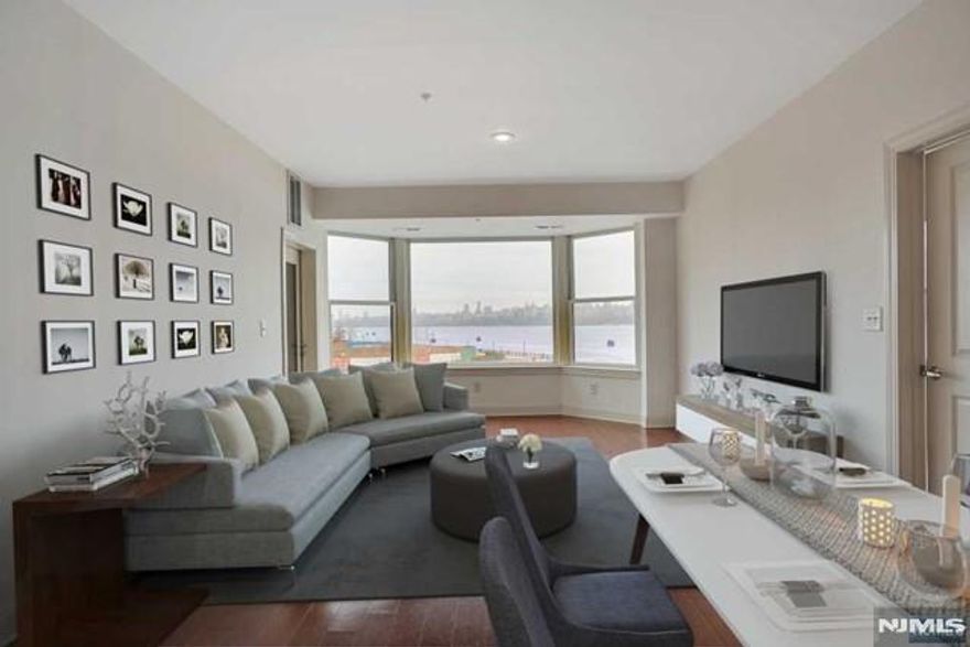 **TAX APPEALED FILED - 13K TAX EXPECTED** Welcome to this stunning Northeast-facing 2BR/2BA residence at the prestigious Grandview II, a premier waterfront community directly across from Manhattan along the Hudson River. Spanning 1,293 sq. ft., this beautifully designed home offers a bright, open-concept layout with breathtaking panoramic views of the NYC skyline and river. The chef-inspired kitchen features SS appliances, granite countertops, & a center island that seamlessly connects to the dining and living areas perfect for both everyday living and entertaining. The living room is framed by oversized windows and opens to a private balcony, where you can unwind while taking in the spectacular waterfront scenery. The expansive primary suite serves as a private retreat, complete with a large walk-in closet and a spa-like ensuite bath featuring dual vanities, a Jacuzzi soaking tub, & a separate glass-enclosed shower. The generously sized second bedroom and full bath are thoughtfully positioned on the opposite side of the home, offering ideal privacy for guests or a home office. Enjoy resort-style amenities including a 24-hour doorman, outdoor swimming pool, state-of-the-art fitness center, business center, resident lounge, and childrenâ€™s playroom. Commuting to NYC is seamless with Ferry, Light Rail, and bus service just steps from your door. With dining, shopping, and a grocery store conveniently located downstairs, this home offers a blend of luxury & lifestyle convenience