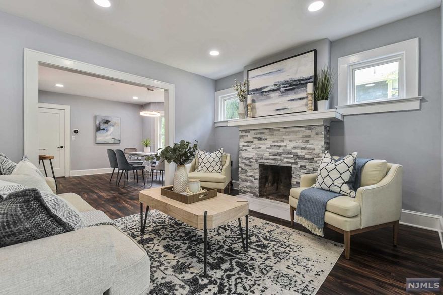 Move right into this fabulous turnkey fully renovated home in desirable Livingston with easy access to shops, salons, restaurants, houses of worship and public schools. The functional open floor plan sets the stage for easy entertaining and holiday gatherings. Welcomed by a cozy vestibule which leads to the living room with a beautifully tiled wood burning fireplace flanked by windows, white molding and recessed lighting. Open to a formal dining room with a bay window. Chef's eat-in kitchen features new custom wood cabinetry, quartz stone countertops, breakfast bar with seating for 3 and all new stainless steel appliances. Outdoor entertaining is seamless via double glass sliders from the kitchen leading to a spacious deck overlooking the private, level yard. Convenient 1st floor den convertible to a home office or a playroom and a powder room completes the main level living. The 2nd level features 3 freshly carpeted bedrooms and a newly updated hall bathroom.