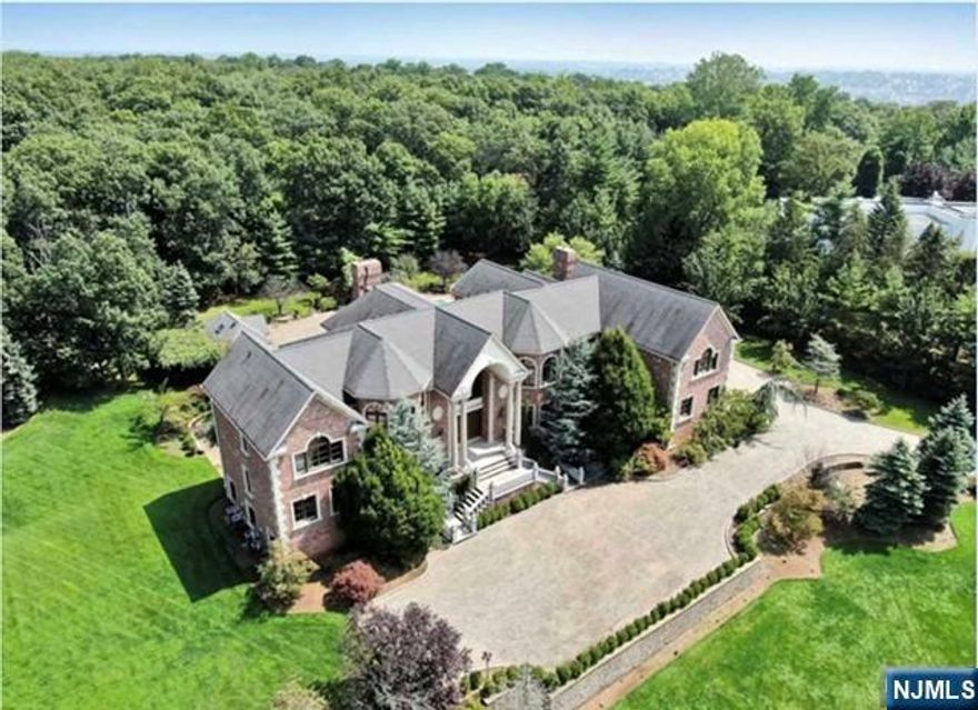 Luxury and elegance collide at this exceptional custom built 2-acre gated estate. The attention to detail is obvious the moment one walks through the door.Soaring ceilings complimented with custom crown molding and extensive hand painted wall art exude a feeling of classic elegance.The stunning brick colonial features 6 bedrooms, 7 bathrooms/2 powder rooms and lush Italian windows and doors throughout.The gourmet kitchen boasts 2 full-size Viking refrigerators, 2 Miele dishwashers a professional Viking stove, wine refrigerator and ice maker. Entertaining is at its height, with a gracious formal dining room, music room as well as a full bar adjacent to the stately living room. A paneled library is accented with stunning built-ins, where French doors access the backyard private oasis with heated pool and cabana, featuring a kitchen and full bath. Ample Parking! Reward school. Minutes from Manhattan.