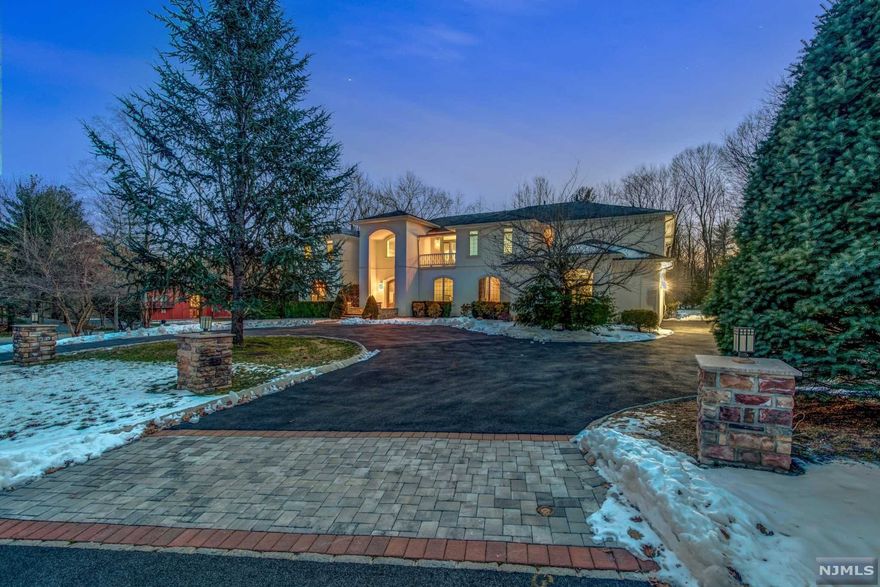 Welcome to this beautifully appointed custom built 7400 sq ft(apprx) Manor nestled at the end of a cul-de-sac on 1.23 acre property. Impressive two-story entry with marble, Brazilian cherry floors open to the spectacular great room with soaring ceilings and huge gourmet kitchen with top of the line appliances. Luxurious master bedroom suite with sitting area, fireplace and spa Master Bathroom. Three additional spacious en suite bedrooms and fabulous home theater complete the second level. Bonus first floor en suite bedroom. Appreciate craftsmanship with details and custom finishes throughout. Taxes have been appealed - the new taxes are $34,454