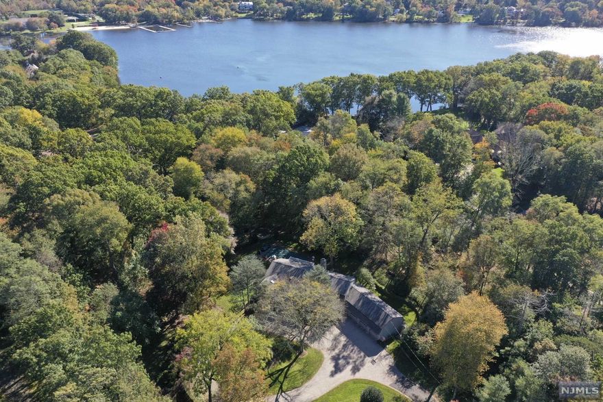 One-of-a-Kind Opportunity- Magnificent Franklin Lakes classic 2.1 Acre property, in prime West Gate Urban Farms location, overlooking Franklin Lake with deeded lake access. The spacious and well-maintained Colonial home features a bright open floorplan w/over 5000 square feet of living space & gorgeous views from every room. Finished W-O LL w/wine cellar, rec room, FB & more. Idyllic private setting with mature landscaping, pool and stone patio. Well-situated, close to the town center and shopping, as well as the renowned Indian Trail Club.