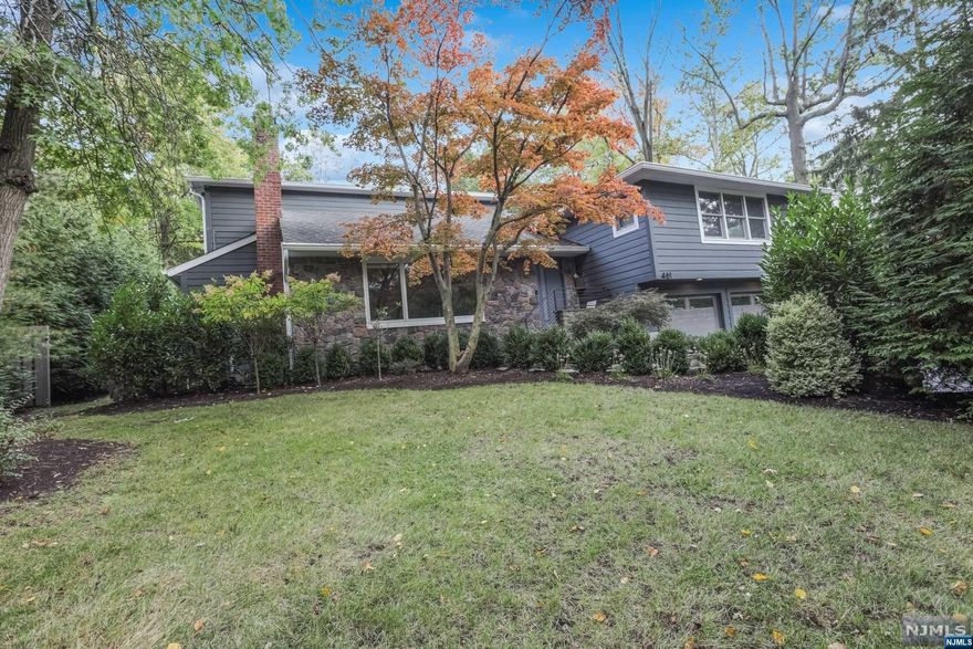 Welcome to this stunning 4 bedroom, 3 1/2 bath, contemporary home with sleek lines & designer touches. Nestled on close to half an acre of lushly landscaped property on Englewood's East Hill. This magnificent home was gut renovated & expanded in 2020. Abundant natural light filters through the large dining room window. The foyer leads to a spacious open-concept living area. The gourmet kitchen features high end appliances, 2 dishwashers, sleek cabinetry & quartz countertops. The beautiful living room is off the kitchen with sliding glass door out to the backyard. The 2nd floor has a bedroom with bathroom en suite, 2 additional bedrooms and full bathroom. The Primary bedroom is it's own private oasis with spa like bathroom, walk in closets, deck and office. The ground level has a 2 car garage, large mudroom with custom cabinets and powder room. The basement is finished with laundry & Rec room. Enjoy the park-like backyard. Close to Houses of Worship, 6 miles to NYC.