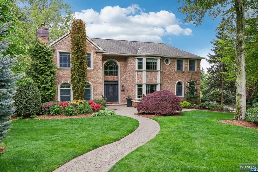 Discover modern sophistication & unparalleled style in this immaculate 2001-built Colonial Manor set on over half an acre in Ridgewood's prestigious Old Country Club section. This home is the ultimate oasis - gunite pool/spa, 5 bedrooms all with full baths, 1st-floor bedroom, oak hardwood floors, 3 fireplaces, high-end appliances, 2-car garage, generator & so much more! A 2-story foyer with flow to large living & dining rooms sets the tone for an interior that is perfect for grand-scale entertaining. At the heart of the home is a natural light-filled family room with fireplace seamlessly connects to a gourmet kitchen equipped with Dacor, Subzero & Miele appliances, marble counters and dining area with glass doors to a spacious deck overlooking the backyard. Primary bedroom retreat on the 2nd floor with walk-in closet, a sitting area with a fireplace & spa-like bath. Finished basement with wet bar, media room, full bath and access to the back patio. Your luxury haven awaits!