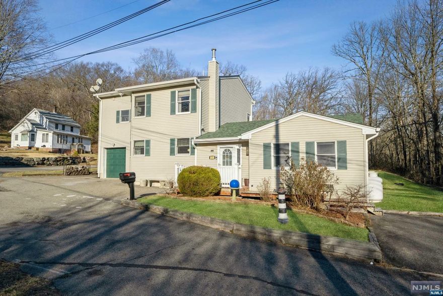 Beautifully Maintained Colonial located at the end of a cul-de-sac in Scenic West Milford. This unique home backs up to private state land and offers 3 large bedrooms w/ walk-in closets, 2nd floor laundry w/ wall shelving, cozy Living Room w/ custom wood beams, updated 2nd floor bathroom, cozy family room w/ wood burning stove & sliding glass doors going out to maintenance free trex deck & spacious fenced in yard, oversized 2-Car Garage, and more! Easy Access to Route 23, Shopping, Restaurants, Schools, etc. Property is walking distance to Thrift Shop, NJ Transit Center & Park & Ride for easy commute into NYC + other popular destinations. Recent Updates include: New Roof (2020)