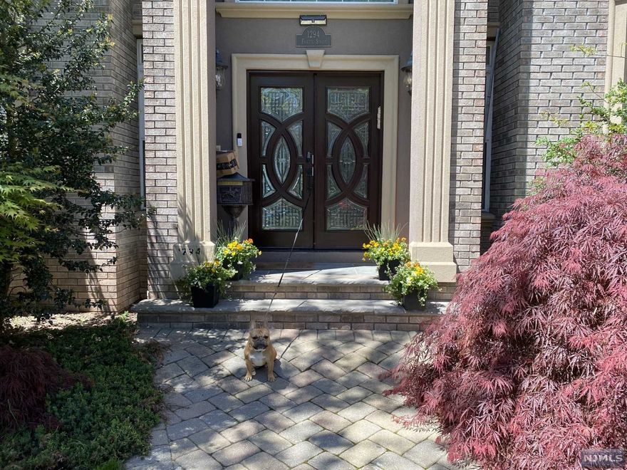 Custom built young colonial with 75 ft frontage & spectacular views of the Ramapo Mountains. 7 bedrooms on second and third floors including Master Suite with sitting room and den. Chef's kitchen, elegant wood paneled library, grand living room and formal dining room, spacious family room with sliding glass doors to excellent deck for entertaining. 9 ft ceilings on 1st floor, all large windows. Generous walk out basement with 2 guest bedrooms, summer kitchen & generous family room. 2 Car garage with separate entrance.