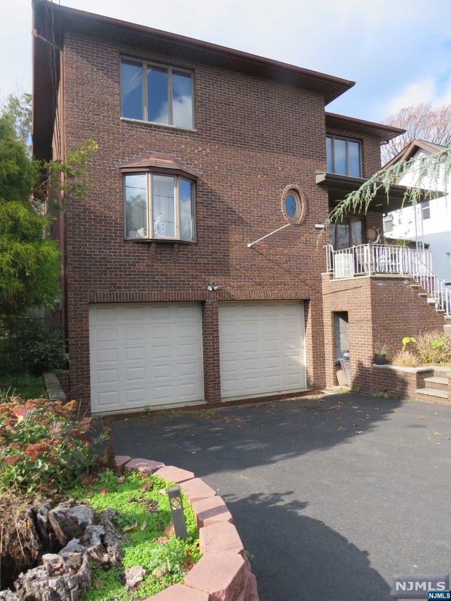 In a Desirable location in Fort Lee is an approx. 3120 sq/ft Four-bedroom 3.5 bath single family brick side hall colonial for sale. 1st floor consists of main entrance, large living room on the right and dining room on the left. The hallway leads to the second-floor bedrooms and straight ahead is your spacious kitchen with direct access to the family room with a wood burning fireplace. sliding glass door provides direct access to the rear two level deck. The second floor contains the large master ensuite with his and hers closets, dressing area and private bathroom. 3 large bedrooms with hallway bathroom finish off the 2nd floor. Ground floor has a bonus summer kitchen, full bath, living room/bedroom with separate direct access from the side yard and to the attached 2 car garage. This home needs some updating and is being sold 'as is'. Easy access to NYC public transportation, shopping, parks, and all major highways. Don't miss this opportunity.