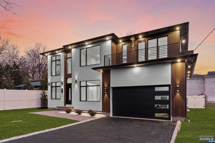 Introducing the epitome of contemporary living in this quality new construction build by award-winning NJGCB. Nestled in a private, wooded dead-end street in the sought-after west side of town, near downtown Ridgewood. Discover this exquisite 6-bed, 7.5-bath haven, boasting +6,000 sf of sheer elegance across all levels. Triple height entry foyer w Pella Lifestyle windows, stunning chef's kitchen w full quartz backsplash & waterfall island & designer appliances, soaring 18' ceiling great room w wet bar & frplce, brkfst sunroom, large dining room & 1st flr guest ensuite complete the main level. Ascend the open riser staircase to the primary suite incl. 2 WICs & spa-like bth,addl 3 large bedroom ensuites, incl. a Juliet Balcony & laundry rm.The walk-out lower level offers a theater, gym, large rec area & 6th bedroom ensuite. Revel in modern aesthetics w contemp siding,energy eff. foam insulated ext. walls,3-zone HVAC, well water, & more! EXIST.