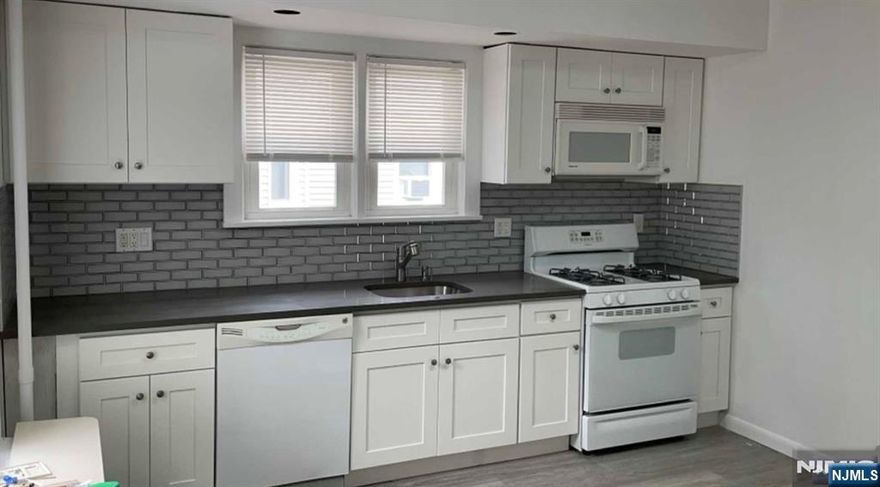 RARE FIND "DUPLEX" ! Live in this RENOVATED " DUPLEX Apartment" NEWER KITCHEN & NEW BATHS.LARGE 3 BEDROOM ... Cheerfully Bright with Natural Sunlight.....Large Spacious Kitchen with STONE Counters, "Gas"Range, Dishwasher, Refrigerator, Recessed Lighting, Rear MUD Room, Washer and Dryer, Hardwood Floors, Large Closets, Ceiling Fans, Central Air. Full Private Basement for storage, and exit to yard. Entertainment Deck and BBQ Area. Front Lemonade Porch! Also included is 1 Garage and Parking ON SITE. Extra bonus = Landlord will care for grass and snow removal. Close to Train, Bus and Village amenities. Excellent Schools!