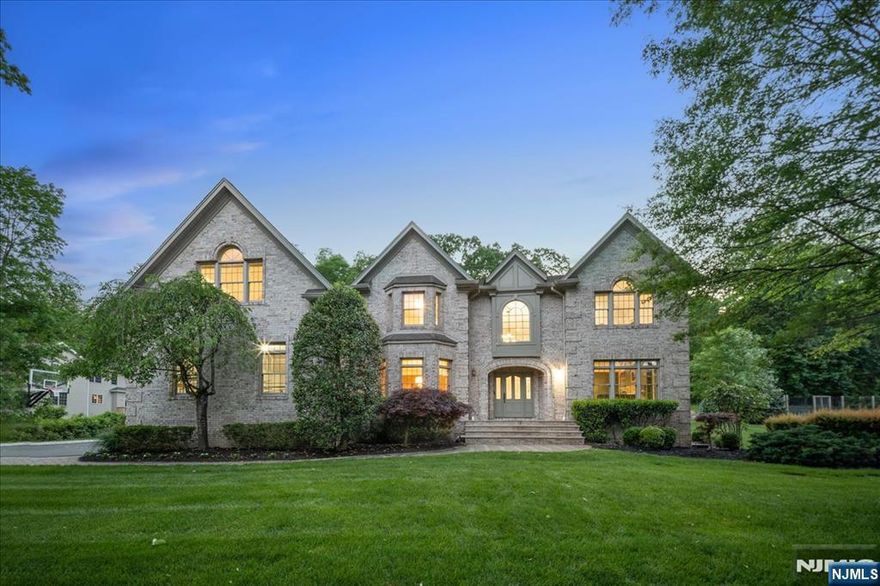 Welcome to this exquisite all-brick manor, tucked away on a quiet double cul-de-sac in desirable Upper Saddle River. The Belgium block driveway & paver walkway lead to a grand 2-stry foyer w/ radiant heated limestone floors & an elegant sweeping staircase. French doors open to a cozy library with built-ins and a marble fireplace, perfect for work or quiet moments. An elegant formal dining room w/custom woodwork & walnut inlay floors sets the stage for memorable gatherings. The butlerâ€™s pantry leads into the newly renovated chefâ€™s kitchen, w/Wolf 36" gas range, Miele double ovens, 2 Miele dishwashers & a SubZero refrigerator that flows into the sunny breakfast area. Host family gatherings in the breathtaking 2-story great room with stone fireplace, wet bar, bev fridge & sliders to the expansive backyard. The main level also offers a walk-in pantry, spacious laundry rm, powder rm, mudroom w/built-ins, guest bedrm, and full bath. Upstairs, the spacious primary suite features dual walk-in closets, a spa-like bath & an ensuite office/bonus room. No one has to share with 3 more ensuite bedrms completing this level! The amazing lower level has it allâ€”an entertaining area which includes a wetbar w/ fridge, sink, dishwasher, a rec area for games, a TV area w/ fireplace, plus a bonus room, gym & 1/2 bath, plenty of storage plus access to the 3-car heated garage. Outdoors, enjoy a large paver patio, expansive yard & the added peace of mind of a Generac generator.Your dream home is