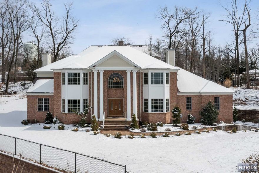 Welcome to this stately Center Hall Colonial perched high on a private cul-de-sac in the prestigious Park Ridge Estates! So much to love about 5 Ledgewood Ct. The soaring 18-ft ceilings & elegant circular staircase in foyer entryway. Spacious family room w/WBFP open to EIK w/center island, SS appliances, & separate dining area. The GREAT room w/cathedral ceilings, gas FP, & windows on 3 sides. The light-filled LR w/coffered ceilings, large formal DR, home office, 5th Bedroom, powder room, and laundry complete the 1st floor. 2nd floor features primary en-suite BR w/tray ceiling, walk-in closet, & luxurious FB including jetted tub, additional en-suite BR w/FB, & walk-in closet, 2 additional spacious Bedrooms, & hall BA. 3 car built-in garage, 3 units of C/A, 4,700+ sq ft on 1st & 2nd floors plus 1,700+ sq ft lower level w/high ceilings & unlimited potential, large flat yard on 0.85 acre lot, gorgeous sunset views.