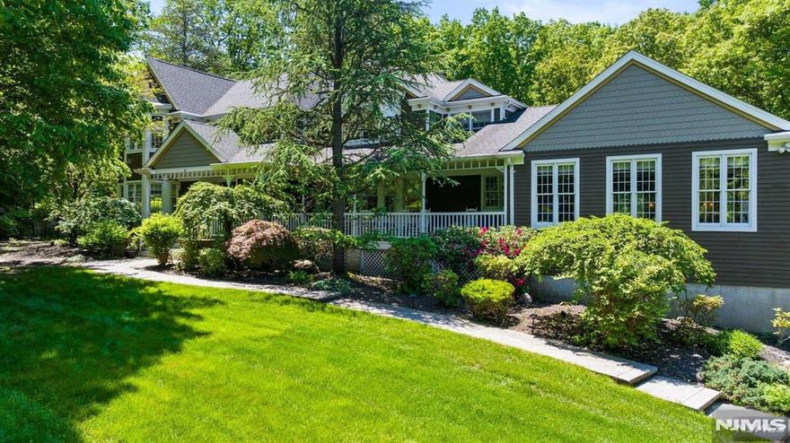 Discover this stunning turnkey custom colonial nestled on a quiet street in Montville Township. Set on a sprawling 2-acre lot, this exquisite home features a covered mahogany porch, a gunite saltwater heated pool & hot tub all surrounded by beautiful blue-stone & lush trees for ultimate privacy. Step inside to a grand two-story foyer with a wrought iron winding staircase & gleaming hardwood floors throughout. The family room boasts cathedral ceilings & a floor to ceiling stone wood-burning fireplace with access to the deck or pool. The gourmet eat-in kitchen is a conversation piece of its own. Boasting quartzite countertops, high-end appliances, center island with seating, coffee bar & a walk-in 1100-bottle temperature-controlled wine room. Entertain in style in the oversized great room flooded with natural sunlight, high ceiling or host gatherings in the formal living & dining room. The first floor also includes a bedroom, laundry room with sink & 1.5 baths. On the 2nd level, the primary suite offers tray ceilings, walk-in closet, loft, and a luxurious bathroom with dual vanities, soaking tub & walk-in shower. Two additional bedrooms, an office/bedroom & a main bath complete the upstairs. The lower level features a finished gym area, 3 car garage access, ample storage & a full house generator, ensuring comfort & convenience in every season. Home is located in Montville Twp. with a Boonton Twp. mailing address.