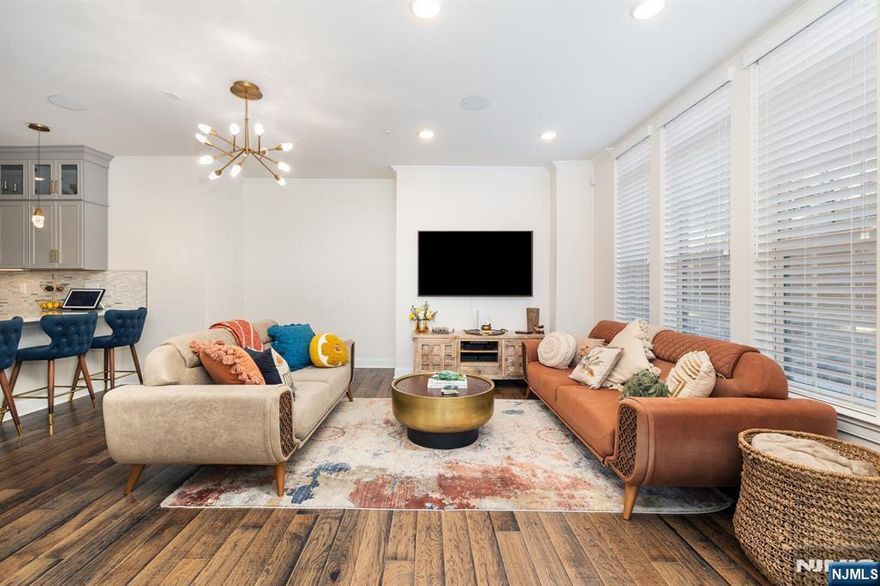 Welcome to Wood-Ridge's most highly sought out townhouse community. 31 Arnold drive is a rare Murray Hill Model built by Pulte Homes, only 2 years old, & has never been rented! This stunning END UNIT has ALL upgrades from builder including: marble sinks, maple cabinets, oak and wrought iron railings, granite countertops, built in Sonos speakers, & so much more (full list in docs). This townhome features open concept LR & dining area w/ stunning kitchen peninsula w/ gold hardware & lighting. There is a convenient (and rare) full bathroom on the 1st floor along w/ backdoor entrance to the attached garage & driveway. Second level features a bedroom, full bath, utilities, laundry & storage, & lovely primary bedroom w/ ensuite bathroom. Home is equipped with Guardian Security System. Take advantage of this unit's low HOA's and 5 year tax abatement. Community includes: onsite train station, coffee & wine shop, dog park, multiple playgrounds, sports complex, close proximity to grocery & more.