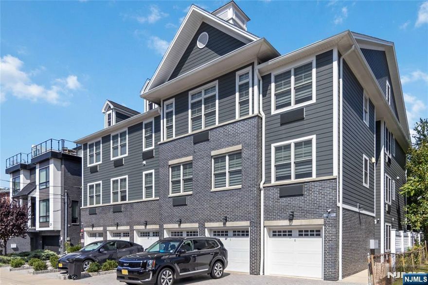 Built in 2019, this modern luxury home offers more than 2,000 sqft of open living space, combining contemporary style and comfort. Set within a well-kept building with low HOA, unit includes a private garage, a extra wide paver driveway. Inside, open-concept layout create a bright and inviting living and dining areas, centered around a sleek modern kitchen ideal for both everyday life and entertaining. Off the living room, a sliding door opens to an outdoor space surrounded by trees and bushes. A bonus room with glass doors provides the perfect setting for a study or home office. A full bathroom on the main floor adds convenience and flexibility. Upstairs, the primary suite features an ensuite bath with both a shower and soaking tub, along with two walk-in closets. Two additional bedrooms share a full bathroom. Second-floor dedicated laundry room. This home offers generous space, modern finishes, and a prime location for NYC commute.