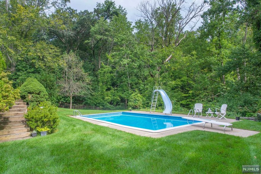 Opportunity knocks! Located in the 'Hollywood Homes' section of beautiful Twp of Washington, this well-loved, expanded ranch sits on just under an acre of land - boasting an expansive, very private rear yard with in-ground pool and patio, perfect for entertaining! First level features a welcoming entry foyer, den, dining room, eat-in-kitchen, large living room with fireplace, three bedrooms and two full baths. Finished walk-out basement offers a sizable laundry room, rec room with second fireplace, bar, half bath and sliding door to patio and pool. A home office and storage room complete the lower level. Conveniently located close to schools, parks, Garden State Parkway/Rt 17 and NYC transportation, and just 2 miles from downtown Westwood. So much potential to update & expand - come make this your dream home! (Sold as is. Exterior photos taken Aug '21.)