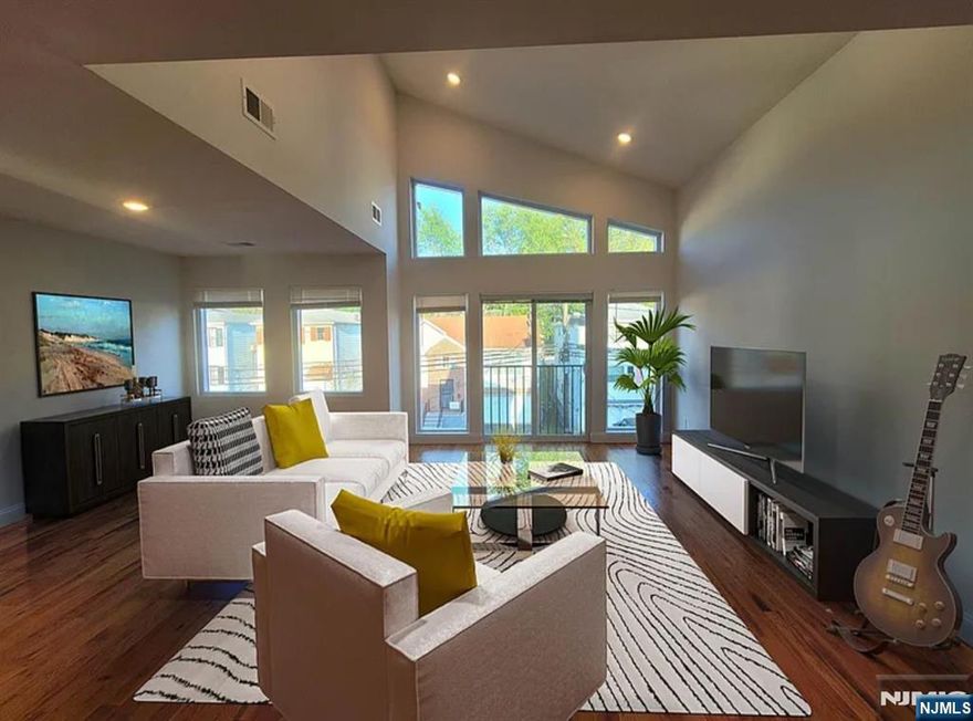 EXCEPTIONALLY DESIGNED APARTMENT LOCATED IN THE VAILSBURG AREA OF NEWARK NJ! This beautiful newly constructed top floor 3 bed/2 full bath apartment has its own private entrance into the apartment. Upon entering, you're welcomed into an enormous light filled living and dining area with over-sized smartly designed windows and large glass doors that slide open to the juliet balcony. This lovely home consists of high ceilings, recessed lighting, central air/heat and hardwood floors, etc. The king sized master suite has an en-suite bath and a huge closet. The other two generously proportioned bedrooms can both fit queen or king size beds. Along the hallway is a closet with a full size washer/dryer and another full bathroom. The eat-in kitchen has an open concept with a beautiful center island, gorgeous backsplash and cabinets, and stainless steel appliances. Located only 3mins from the bus stop, 12mins to trains. Live, work and thrive in Newark.