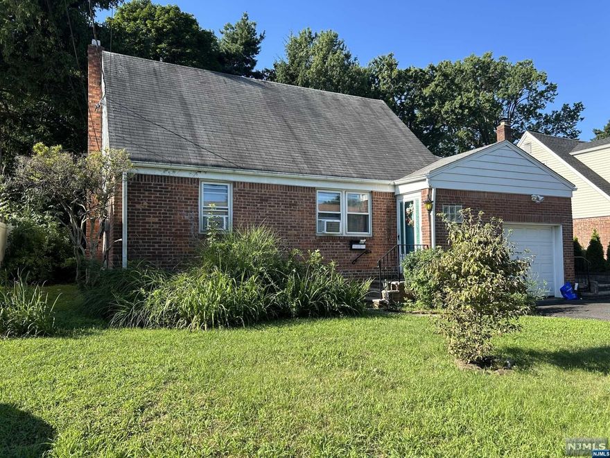 This home offers a brick front, double wide driveway and nice, deep backyard. The entry foyer has a coat closet and opens to the living room. There are two bedrooms on the first floor. One is the primary and a nice full bath. The eat in kitchen has a side door to the patio and backyard area. There is a huge unfinished walk-up attic area and a nice size unfinished basement with high ceilings. Lots of potential. Close to NYC transportation, schools and shopping. The roof and retaining wall are as is.