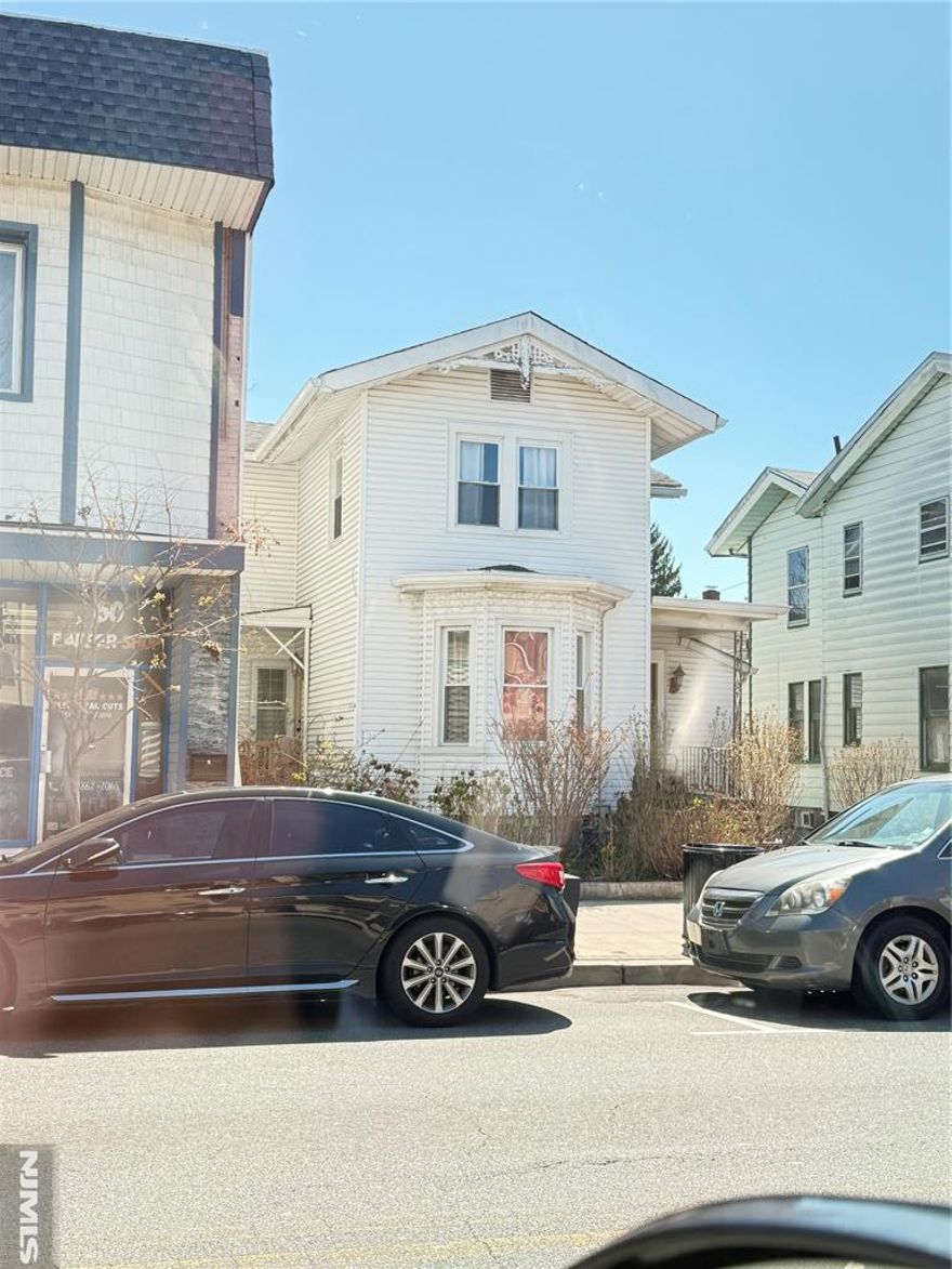 Situated in Garfieldâ€™s redeveloped and sought-after â€œRestaurant Rowâ€ district, 56 Passaic St. is a fully leased two-unit residential property featuring 2 two bedroom units and has potential for commercial conversion usage. Endless developer potential. This property includes 3 parking spots in the rear and is just one block from the train station and offers easy access to the Parkway, Route 46, and Route 80. This is a rare opportunity to acquire an income-generating asset in a high-demand area. Property is located in an opportunity zone and is sold as-is. The owner holds a New Jersey Real Estate License.