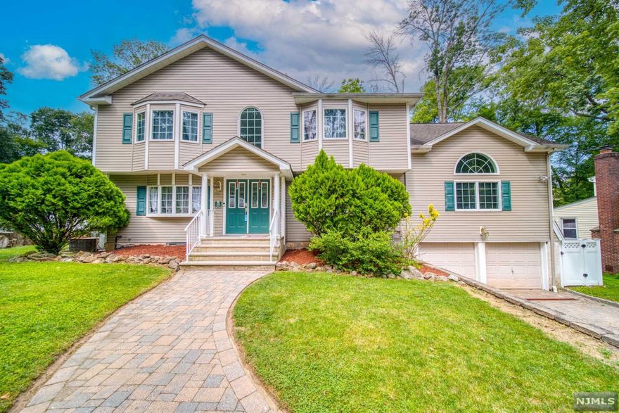 Located in Packanack Lake Association! This oversized Colonial is featuring 4 bedrooms, 3 full baths, 1 half bath, newly renovated Chef' kitchen with a large island and direct access to the backyard! 2 story entry leading to open concept living room with a wood burning fireplace, dining room and kitchen with top of the line appliances. One bedroom on main floor, half bath and the hallway leading the 2 story great room with stone fireplace (gas) and staircase leading upstairs. Primary suite retreat for everyone with a large walk in closet and private bathroom. Full bathroom and 2 greatly sized bedrooms. Pull down attic stairs for access. Basement is fully finished with access from garage (2 car) with a mudroom, another room for an office/workout, laundry room and full bathroom- easy access to the backyard from here as well. A tropical oasis in the back with liner in-ground saltwater pool with heating, a fully fenced in yard and paver patio. Access of the beaches, lake, clubhouse