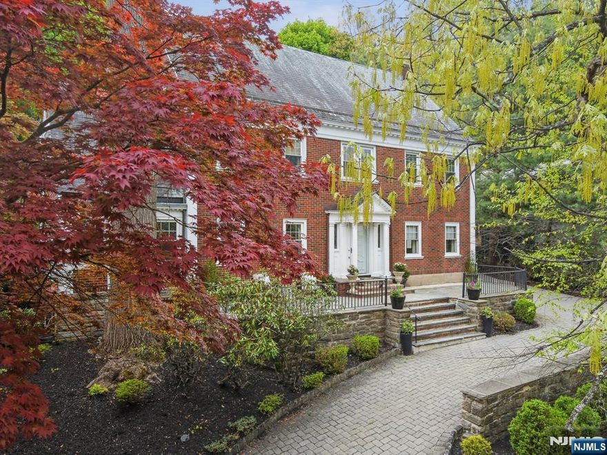 Elevated Living, Effortlessly Styled! Perched on Montclair's coveted First Mountain with sweeping NYC skyline views, this classic Center Hall Colonial blends timeless architecture with a fresh, design-forward sensibility. With 6 bedrooms, 4 full baths & a half bath, this stately gem offers beautifully scaled rooms and an easy, elegant flow for comfortable, modern living. At its heart, a light-filled conservatory-style kitchen that becomes the place everyone gathers for morning coffee, late-night conversations, and everything in between. Thoughtful sightlines, curated finishes-it's a home that feels both polished & completely livable. Fabulous living spaces including finished basement with bar, sink & fridge-perfect for slumber parties. Privacy abounds out in the newly designed rear hardscape-a true destination with an expansive patio, built-in bar & plenty of spaces to lounge, dine, & entertain. A charming turreted pavilion offers covered outdoor dining, rain or shine, adding a storybook moment to an otherwise very hip setting. Out front, take in skyline views that remind you just how close, and yet how far, you are from it all. A rare combination of elevation, privacy, and style! Montclair living at its most compelling. See floorplans, video & 3D tour for more detail.