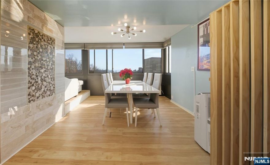 A rare three-bedroom Corner Unit, Fully Renovated and ready to be your new home! Over extended kitchen with Lots of Storage, Newer Appliances, Ventilated Hood, Quartz Counters and Breakfast Bar! Over 1800 Square Feet boasts all the space you need to live comfortably all around! Bonus Space with all-around windows makes the perfect nook for an office, play, or seating area. Stunning eastern views of GW Bridge are sure to create the perfectly lit setting for your nights to enjoy. Primary Suite has Large Walk-in Closet and Updated Bath with Standup Shower. Two more nice size rooms and a guest bathroom complete this layout. Well maintained high rise building with recently updated lobby, hallways and laundry room. HOA fees include All Utilities such as electric, heat, AC, hot and cold water. Basement storage and an indoor garage parking space also included! Pet friendly building. Walking distance to Hackensack Meridian, NYC Bus Stop, Essex St. Train Station, shops, restaurants, and more!