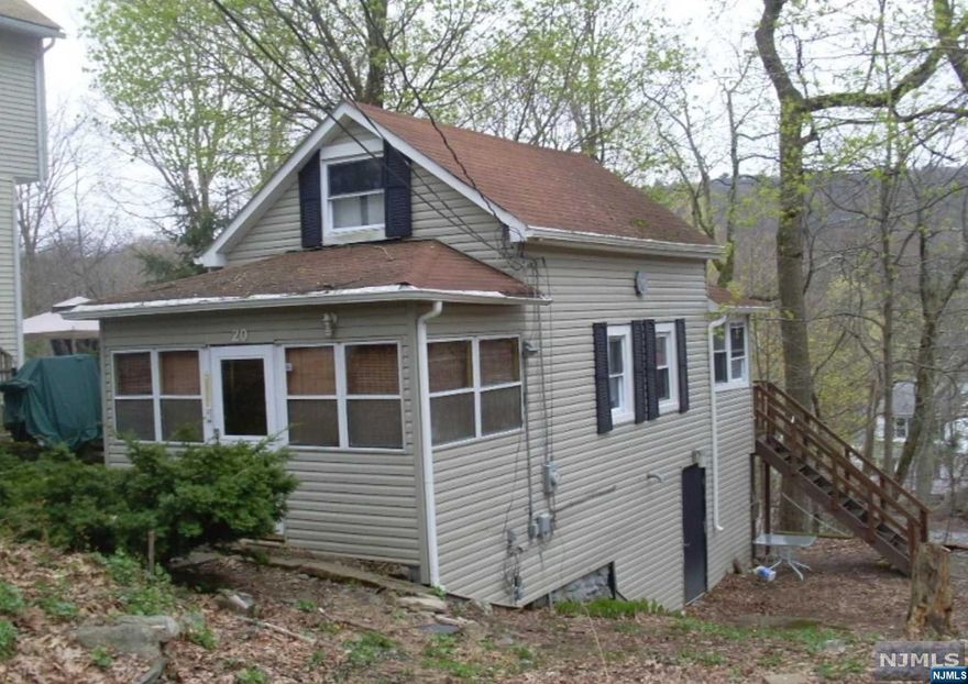 Small Cabin with Extra large lot with possible subdivision. Picture yourself living among the tree's & lake of Upper Greenwood Lake. Bring your imagination and make this house your lake home or next Vacation rental. This home needs full renovation. New water well and central forced air heating unit recently installed. The Buyer is responsible for all test, inspections or CO needed to close and due diligence of possible lot subdivision. This property is being sold in AS IS CONDITION. Cesspool on the property. The buyer is responsible for installing a new septic.