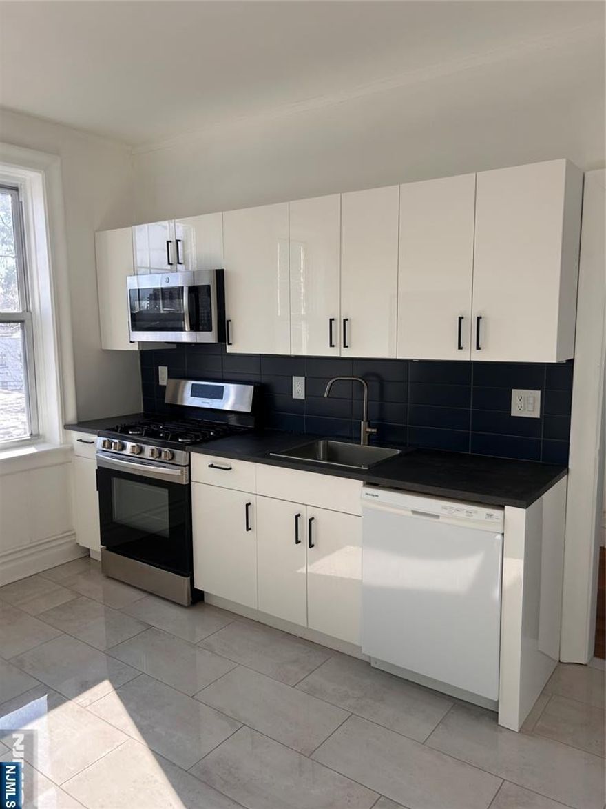 This beautifully updated apartment combines classic character with modern comfort. This bright, spacious units feature 9' ceilings, hardwood floors, a modern kitchen, and quality finishes throughout. Conveniently located near shopping, dining, parks, and transit, offering quick access to NYC, Edgewater, major highways, and direct NJ Transit service to Port Authority. Whole Foods, Trader Joeâ€™s, cafés, and neighborhood favorites are just minutes away. Heat and Hot water are included in rent! Shared laundry available in the building! Don't miss this opportunity, schedule a tour now!