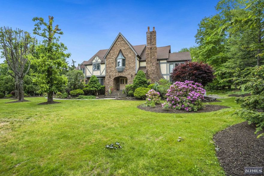 This kind of home does not come on the market often. Custom Built 4600 Sq. Ft. 5 Bedroom, 4 1/2 Bath Tudor located in the Mansions at Montville. 1st Floor features a double door entry foyer, Sunken LR w/spiral staircase to library, marble fireplace, Dining Room, Fabulous great room w/wood burning fireplace & sliders to deck. Eat-in-kitchen w/center island, BR/Office, Laundry, Full Bath, 1/2 Bath. 2nd Floor Features 3 Bedrooms w/walk in closets, Full Bath. Stunning Master Suite w/ 3 walk in closets, Master Bath w/jacuzzi tub, stall shower & Bidet. 3 Car Oversized Garage, Professional landscaped w/sprinkler system, Hardwood floors, Whole House Generator are just a few of the many amenities this home has to offer. Full finished basement w/full bath. Million Dollar Neighborhood, Top Rated school district.