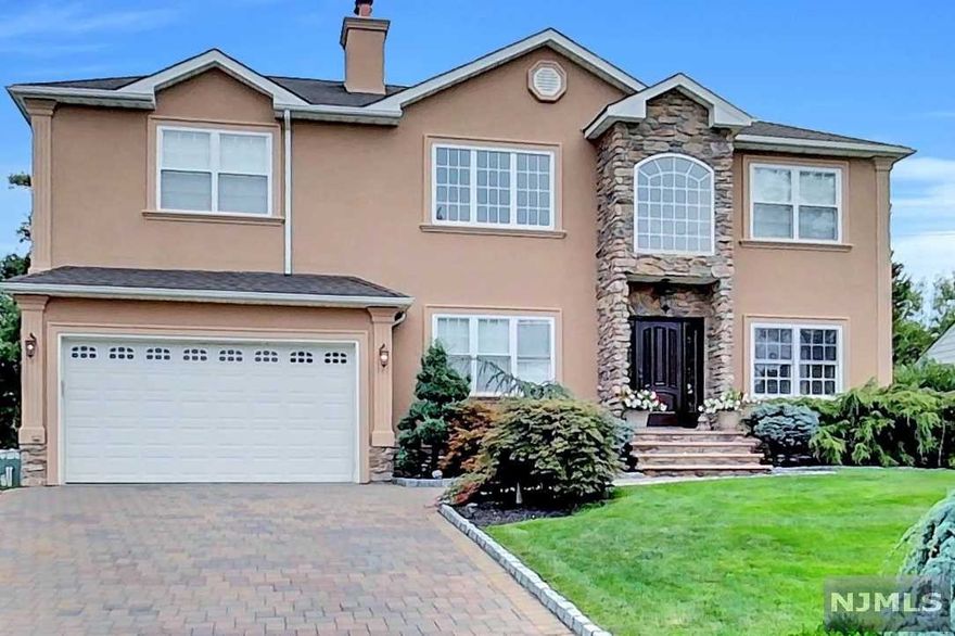 Stunning Custom built home! Step into this Beautiful Home with cathedral Ceilings, Stone Fireplace and Crown Molding throughout. Kitchen with breakfast bar peninsula, wine cooler, dining table, Granite Counter Tops, SS Appliances and plenty of elegant cabinetry that overlooks the Family Room. Office Space on the same level or could be the 5th Bedroom. Large Laundry Room on the same level. Exquisite Master Suite with Vaulted/Tray Ceiling, His and Her Grand Closets, and huge private Bathroom W/Jacuzzi tub and glass stall shower. A princess suite with Hollywood style bathroom, plus two more Bedrooms. There's a touch of elegance everywhere you look! 2 attached Garages, and 4 parking spaces all Paved including walkways. Exterior Bar and paved patio. Don't delay, a Must See.