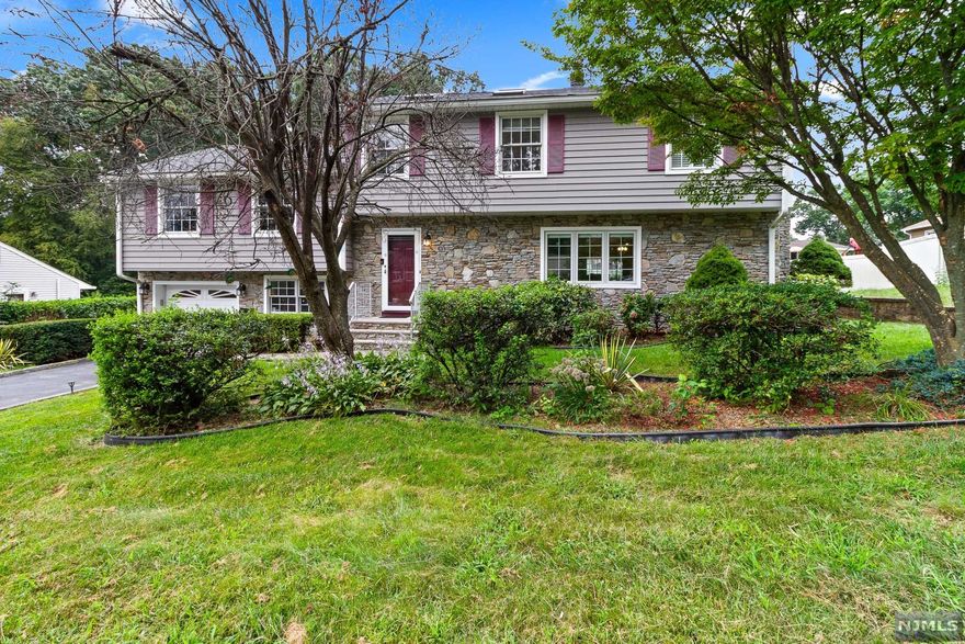 Welcome home! This beautiful and well maintained split level home has 4 possible 5 bedroom, 2.5 bath. Enter into the living room with beautiful stone gas fireplace, formal dining room, updated eat in kitchen with granite countertops, large center island. This kitchen has top of the line appliances- sub zero refrigerator and Wolf range with double wall oven. Next level boasts a large family room with skylights, den, private master bedroom suite with updated bath, oversized shower and double sinks. Making your way back downstairs the grand Pella sliding glass doors lead to an entertainers delight with large trex deck overlooking private yard with heated in ground pool. Some features include paver front walkway, attached garage, 3 zone heat, central air, HW floors, underground sprinklers and so much more!! This home is a must see- so many options including a possible guest suite!