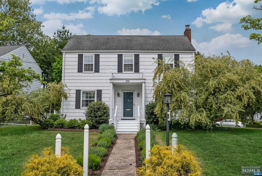 Welcome to this delightful colonial radiating timeless charm and character. This idyllic home boasts over 2000 sf of living space on 3 floors on a picture perfect corner lot. Upon entering, you'll be embraced by a cozy and welcoming atmosphere. Find a spacious family rm, featuring a wood-burning fireplace that extends into the sun-drenched mud rm/office (or use as a playroom or sitting room) opening thru beautiful glass doors to a private deck with outdoor TV! A kitchen with all modern amenities opens to a well appointed DR and also has sliding glass doors to the deck. Upstairs find Primary Suite with roomy WIC, 2 more Br's, and a Hall Bath. HW floors throughout and central air/gas heat complement the home's other amenities. Finished LL offers a rec room/office, large closets, pantry, laundry, storage. Conveniently located near top-rated schools, parks, shopping, and places of worship AND an express bus to NYC located across the street. Perfect!! Don't miss this sweet gem.