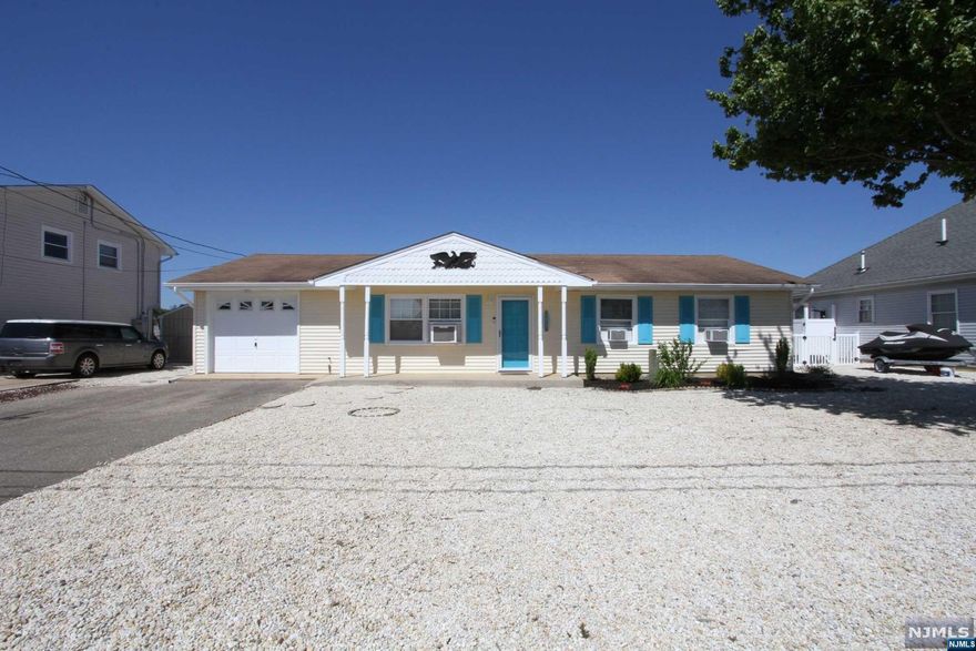 Immaculate sun-filled updated Ranch with 70' of water frontage in highly desirable Pebble Beach! Newer bulkhead and dock 2017! Low maintenance home and property is close to Pebble Beach of Barnegat Bay! Open concept living room (17'8" x 13'10") opens onto dinette (11'6" x 11') with U shaped kitchen (8'7" x 8'6") that offers many updates, including designer countertop, glass tiled backsplash, and newer stainless steel appliances. Year round heated sun room with 6 updated windows along 3 walls offering scenic views of lagoon and rear yard; plus door to yard! Three generous sized bedrooms and large updated bathroom with double vanity. Newer luxury vinyl plank (wood-grain) flooring. Updated easy glide sliding glass door. Recently painted interior. Gas hot water baseboard heat allowing for year-round comfort. Updated 150 amp electric service. Attached garage and shed. Whether wanting a year-round home or a wonderful summer get-away, you will be pleased with what this home has to offer.
