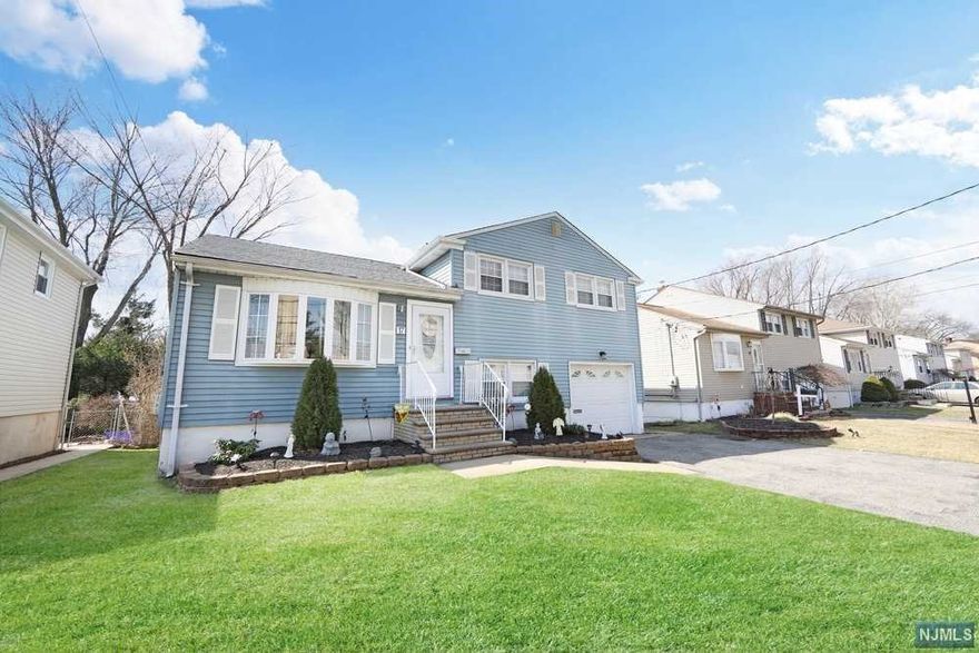 Welcome to this immaculate well kept split-level home on a quiet street. This home is truly a "turn key" home. On the main floor you have the living room, eat-in-kitchen and dining room. Off the dining room are sliding doors that lead you to a large covered deck with a full working outside kitchen and pizza oven. This is a great area for entertaining! Upstairs you will find three bedrooms and a beautiful full bathroom. On the ground level you have the family room, laundry room an another beautiful half bathroom. There is also an entrance to the backyard and the garage as well. In the basement you have the utilities and another large area that can be used for an additional family room. The home has a new furnace, hot water heater, central air and a new roof. Great location! Close to NYC transportation, shopping centers, schools and parks