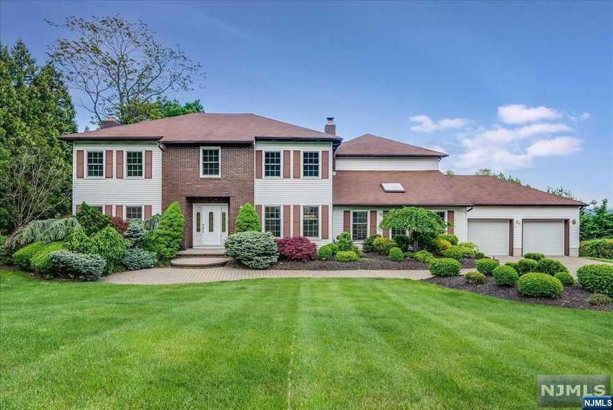 Hawthorne Heights' 5BD/4BTH COL 4,490 Sq Ft of luxe living space, breathtaking NYC skyline views, and lush foliage. This mini estate features a 3 tier backyard and is less than 30 minutes from NYC via town train station. The 1st level offers foyer, FLR w/HW, WBFP, and recessed lighting, leading to the FDR w/main deck access, updated EIK w/breakfront cabinet w/wet bar, soft-close cabinets, granite countertops, SS appliances, and a 6-burner hooded stove, large sunken FR w/cathedral ceilings, a skylight, HW, and a floor-to-ceiling stone WBFP. Adjacent is a sunroom w/NYC skyline views, wet bar, refrigerator, wine cooler, and two decks access. There is a full bath and 2-car attached garage access. The 2nd level offers a Prim suite w/ sitting room, WIC, and an ensuite bath, 4 add'l BD, 2 BTH, and laundry room. The GR level has flex space, laundry area, and w/o to backyard, curb appeal, 4+car parking, and cl to downtown, Goffle Brook Park, and major highways.