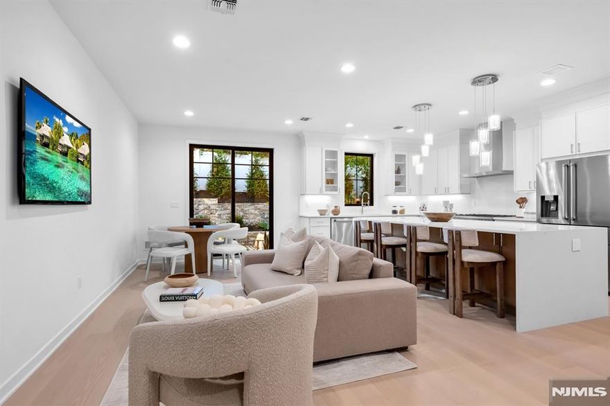 Luxury new construction interior townhome unit at Liger Estates, offering modern finishes and everyday comfort in the sought after town of Oradell. Built by Rock Solid Builders, this residence features 3 bedrooms, 2 full baths, and 2 half baths, with high ceilings creating an open and functional layout throughout. Open concept living with the kitchen featuring custom cabinetry, stainless steel appliances, quartz countertops, and sliding glass doors leading to a patio and backyard. The primary suite includes two custom walk-in closets and a bathroom with a soaking tub, oversized shower, and double vanity. Two additional bedrooms share a full bathroom, with a conveniently located laundry area on the same level. A fully finished lower level provides additional living space, complete with a recreation room and half bath, perfect for entertaining, a home office, or a gym.Enjoy outdoor living with a serene patio and professionally landscaped surroundings that complement the home's modern architecture. Conveniently located near top-rated schools, dining, shopping, and transportation, this luxury townhome delivers refined living with exceptional convenience.