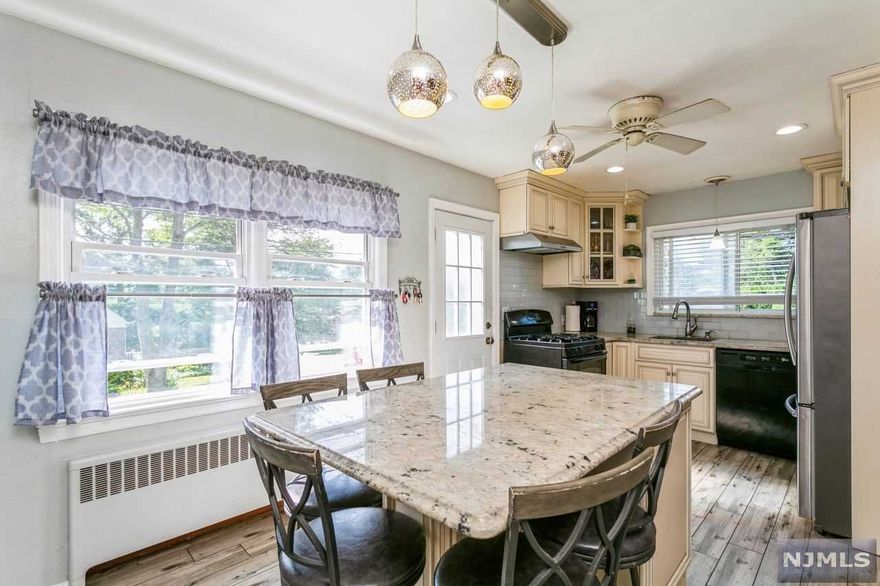 This lovely 3-bedroom, 2 full bath ranch style home welcomes you onto the covered porch and into the spacious living room with picture window, updated, bright kitchen with center island dining area and door to side entrance, 2 spacious bedrooms and a full bath complete the 1st level. The lower level offers a full, finished rec room, bedroom, full bath, and door leading to the fenced-in rear yard, wood patio with built-in seating, and walkway leading to shed. Multi-zone heating, wall AC units. Maintenance free brick & vinyl exterior. Conveniently located close to NYC transportation, parks, schools and more.