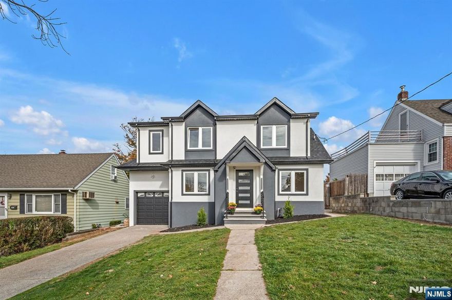 Beautiful new colonial home in the heart of Hackensack! Conveniently located near two NJ Transit train stations, the downtown bus transfer station, and Hackensack University Medical Center, offering easy access to NYC and surrounding areas. The first floor features a bright living room, eat-in kitchen with coffee bar, dining area, bedroom, and full bath. Upstairs includes a spacious primary suite with en-suite bath and walk-in closet, plus an additional bedroom and full bath. Finished basement perfect for entertainment, a one-car garage, sprinkler system and security cameras complete this move-in-ready home close to shops, restaurants, and parks.