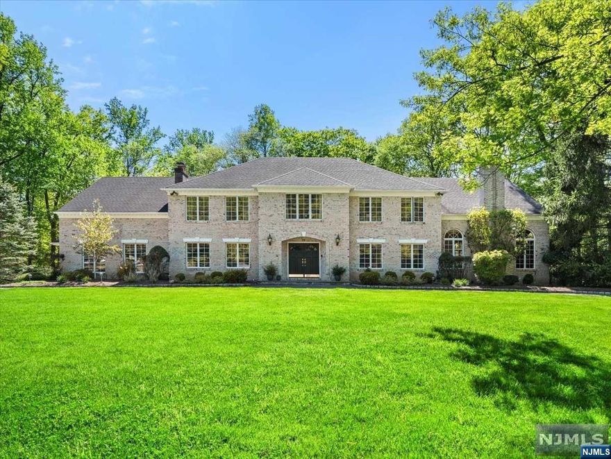 Nestled at the base of a cul-de-sac, this Ramsey estate is available for the first time in over 20 years. Set upon 2.5 acres of private land, this residence is an entertainer's haven, where a vaulted-ceiling great room is complemented by an expansive dining area, a spacious kitchen, and an inviting family room. Beyond lies a sanctuary surrounded by mature landscaping, boasting a pool, built-in grill, fireplace, cascading waterfalls, hot tub, and even space for a par 3 golf area. Adorned with stunning stone patios, every detail has been finely crafted. A main-level bedroom and full bath offer convenience. Upstairs, a primary suite is accompanied by 3 large bedrooms and a hall bath. A rare versatile space awaits with an invaluable extended family apartment, with a separate entrance, a living room, and a private bath. A finished basement completes this estate. Homes of this caliber, in such coveted locations, seldom hit the market. Don't hesitate to make this your dream home!