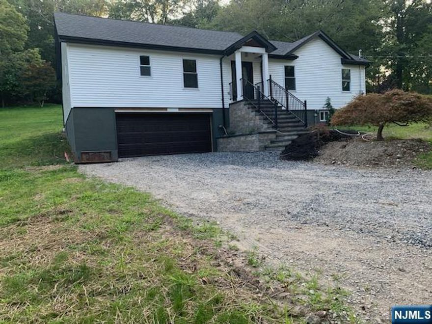 Every aspect of this home is brand new. The house boasts a prominent master wing that provides a luxurious retreat. The oversized bedroom is a haven of comfort, complete with a spacious walk-in closet. The en-suite bathroom is designed for relaxation, featuring a double sink, a soaking tub, and a private stall in an oversized bathroom space. The open-concept kitchen is a chef's dream, equipped with all stainless-steel appliances, ample cabinets, and elegant granite countertops. The center island, accented with a tile backsplash and floors, provides both functionality and style. From the kitchen, you can access the custom paver patio and garden through sliding doors ideal for enjoying peaceful moments surrounded by nature's beauty. The living room, with its sleek laminate floors, offers a cozy yet sophisticated space for gatherings. This area leads to a second full bathroom and two additional bedrooms. Descend the staircase to discover a fully finished basement, offering versatile space that can be tailored to your needs. This level includes a storage area, laundry room, and a convenient half bathroom. Additionally, the basement provides direct access to an oversized two-car garage, ensuring both security and convenience. The property sits on a lot just shy of an acre, providing ample space for outdoor activities. Whether you envision gardening, hosting barbecues, or simply enjoying the open air, this expansive yard offers endless possibilities.