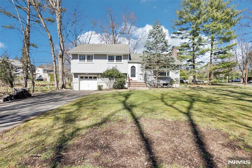 Welcome to this beautifully renovated split-level home, nestled on a peaceful cul-de-sac just steps from the train station & lively Glen Rock downtown, elementary school, municipal pool and park. Every inch of this home has been meticulously updated, offering modern living in a prime location. House underwent gut renovation in 2023, which included installing new heating and AC systems, plumbing, floors, lighting, new modern kitchen & bathrooms, and a new deck. The open concept great room incorporates kitchen, dining and living spaces. It features soaring ceilings, a dual-function gas/wood-burning fireplace, and a seamless access to deck - perfect for entertaining year round. Lower level family room with powder room, and finished basement offer additional recreational spaces. Primary bedroom with a private bath; two additional bedrooms & bath complete the top level. This is a rare opportunity to own a stunning home in a sought-after area with convenient access to everything you need.