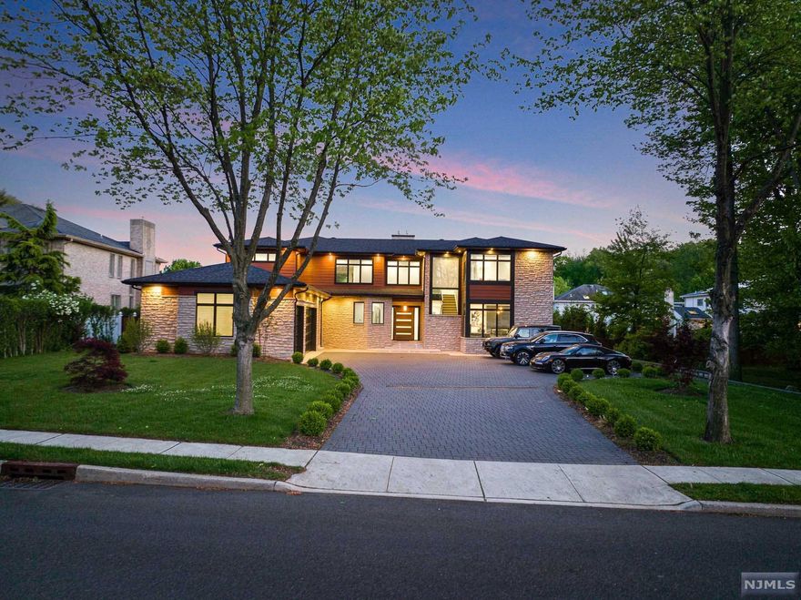 Nearly 10,000 Sq ft of smart home luxury in the booming low tax town of Paramus. Features include Designer kitchen/bathrooms/ spa, a wide open floor plan, 2 laundry rooms, a doggie wash, movie theatre, gym, wine room, outdoor kitchen & 6 large suites.Giant Pella windows welcome in plenty of sunlight & the entire exterior is maintenance free. Convenient location for commuters. The VIRTUAL TOUR link for this listing contains an enormous amount of relevant information including a comprehensive video tour with hidden features & room dimensions, written description, additional photos, floor plans, and a complete interactive 3D model of the home.